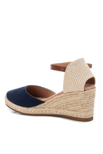 Xti Wedge Sandal. Women's espadrille wedge sandals with a navy, microfibre faux suede upper, a faux leather strap, a 7cm jute wedge and a non-slip rubber sole.