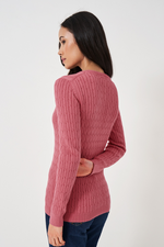 An image of a female model wearing the Crew Clothing Heritage Cable Knit Cotton Cashmere V-Neck Jumper in the colour Rapture Rose.