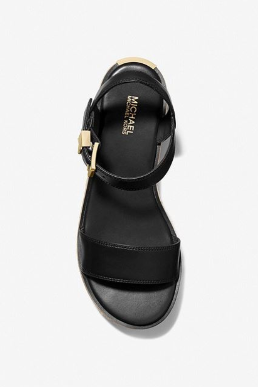Michael Kors Richie Platform Espadrille Sandal. An open toe sandal with buckle fastening, a rubber sole and a chic woven jute platform