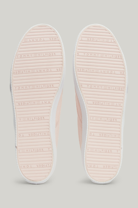 An image of the Tommy Hilfiger Enamel Flag Slip-On Canvas Trainers in the colour Whimsy Pink.