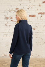 Lighthouse Shore Jersey Sweatshirt. A relaxed fit sweatshirt with a funnel neck, zipped half placket, faux leather zip pull, and two handy pockets.