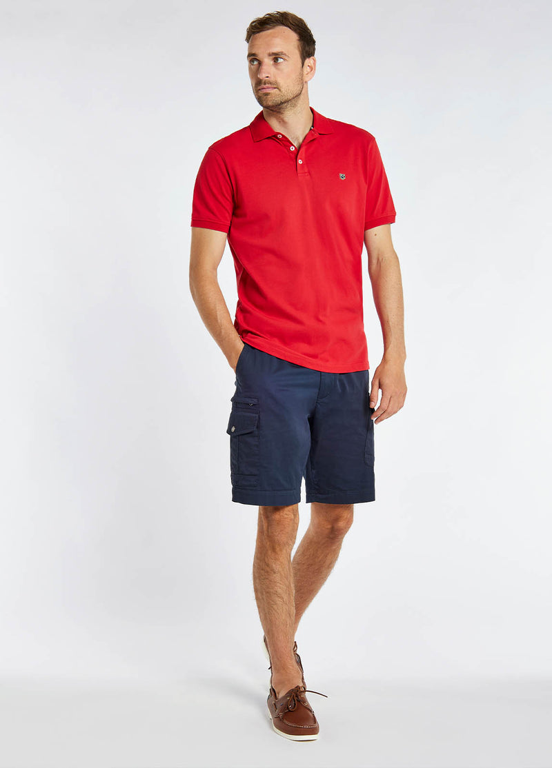 Dubarry Quinlan Polo Shirt. A short sleeve polo with collar, button fastenings, logo embroidery, and anti microbial/UPF 40 finish. Engine Red.