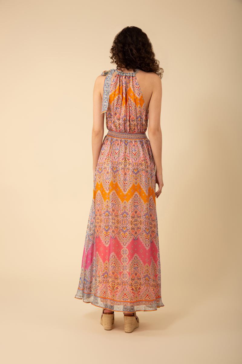 An image of a model wearing the Hale Bob Vera Halter Maxi Dress in the colour Orange.