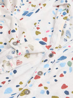 White Stuff Annie Printed Cotton Shirt. A slim-fit, women's shirt with a V-neck, button fastening and a colourful small heart print on a white background.