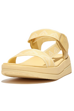 Fitflop Surff Webbing Back Strap Sandals. A pair of yellow chunky sandals with wide strap featuring an arrow print design and microwobbleboard cushioned sole.