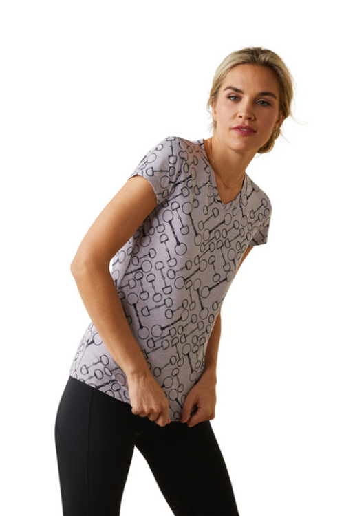 An image of a female model wearing the Ariat Snaffle Short Sleeve T-Shirt in the colour Lavender.