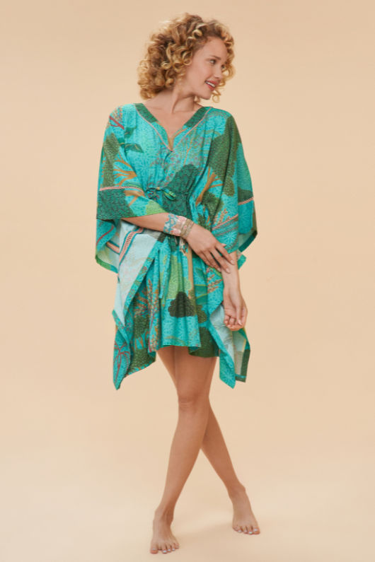 Powder Beach Cover Up. A throw over dress with a drawstring waist for a customised fit, side sleeves, and a vibrant all-over print.