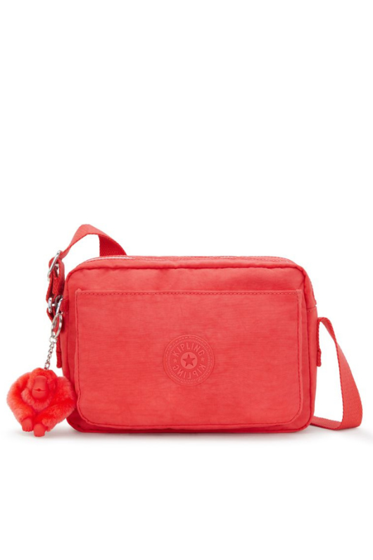 Kipling Abanu Medium Crossbody. A coral crossbody bag with adjustable strap, 2 zipped compartments, multiple pockets, and Kipling logo/monkey charm