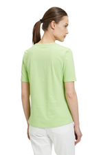 An image of a female model wearing the Betty Barclay Basic T-Shirt in the colour Green Mint.