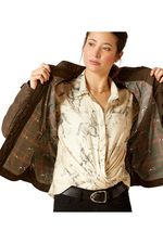 An image of a female model wearing the Ariat Woodside Jacket in the colour Earth.