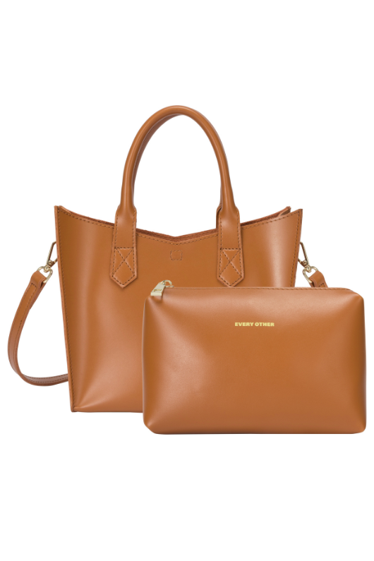 Every Other Twin Strap Grab Bag. A tan faux leather bag with top handles, crossbody strap and removable pouch.