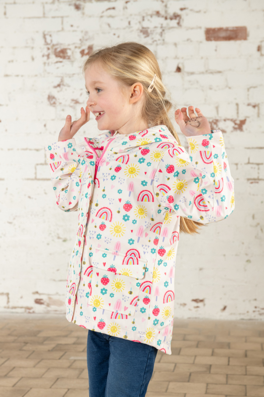 Lighthouse Heidi Jacket. A kids, waterproof coat with a soft jersey lining, and a sweet rainbows & sunshine design on a white background.