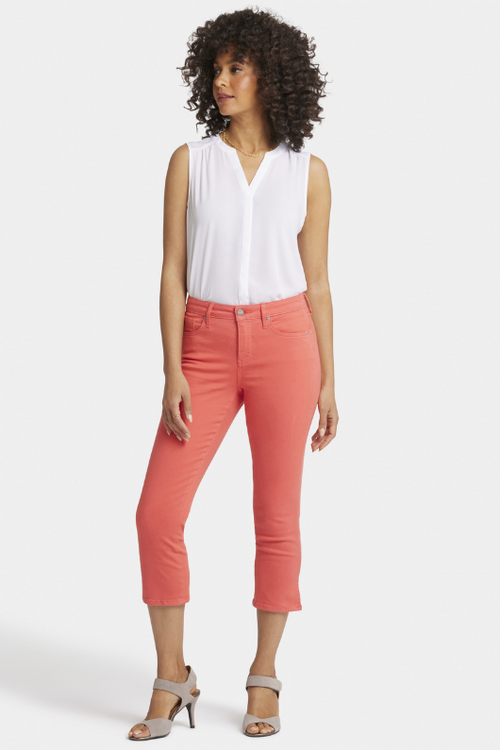 N.Y.D.J Chloe Capri Jeans. Women's cropped jeans with a slim fit, pockets, side slits at the hem, and a chic orange colour design.