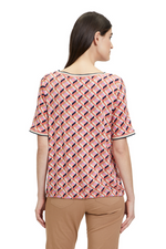 An image of a model wearing the Betty Barclay Tie Pattern T-Shirt in the colour Red/Beige.