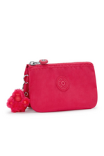 Kipling Creativity S Purse. A small zip purse in vibrant pink with a round Kipling logo on the front and a fluffy Kipling monkey keychain.