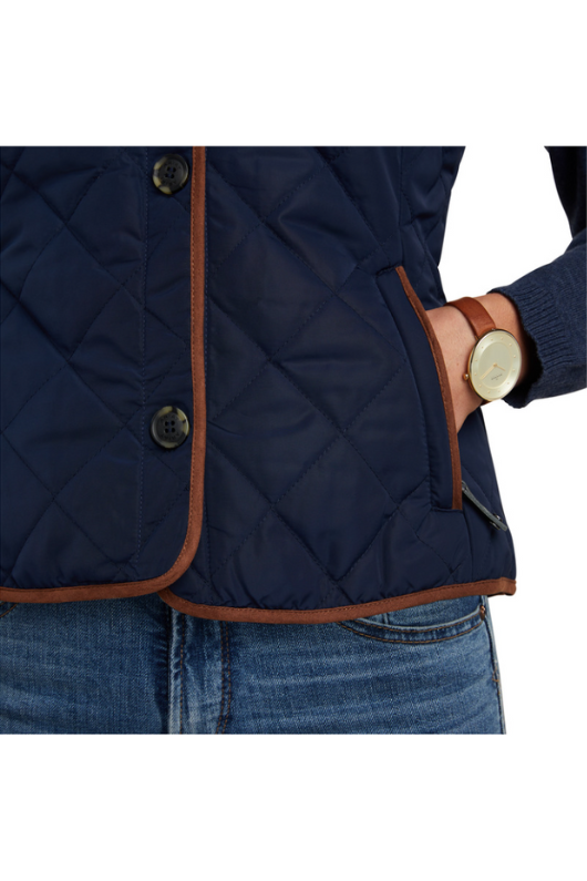 An image of a female model wearing the Ariat Woodside 2.0 Quilted Gilet in the colour Navy.