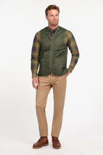 An image of a male model wearing the Barbour Quilted Waistcoat/Zip-In Liner in the colour Olive/Classic.
