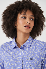 An image of a female model wearing the Crew Clothing Lulworth Shirt in the colour Blue Floral Print.