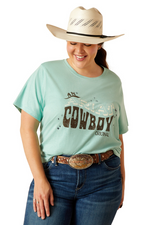 An image of a female model wearing the Ariat Cowboy T-Shirt in the colour Aqua Heather.