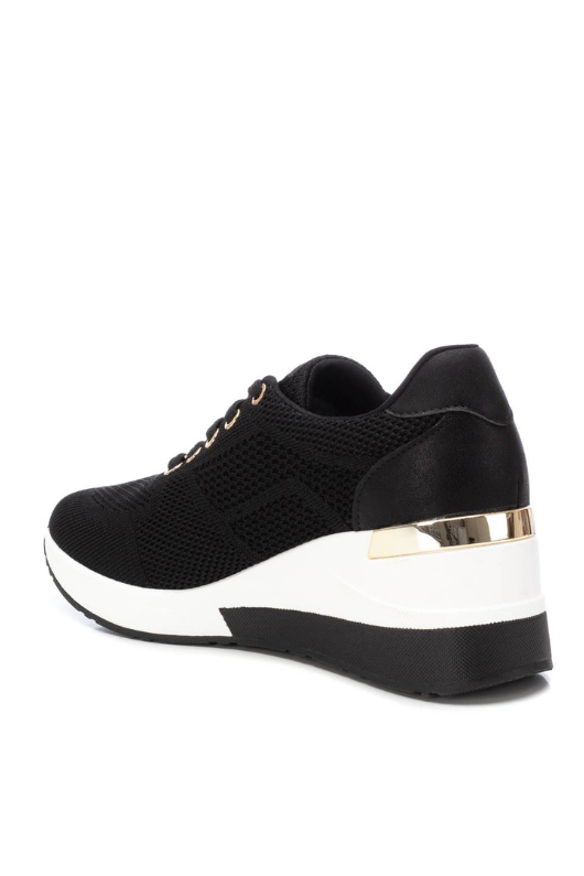 Xti Trainer. A women's wedged trainer with lace-up fastening, a 6cm wedge heel, and a non-slip rubber sole