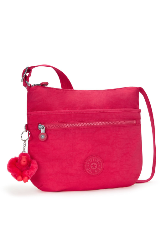 Kipling Arto Shoulder Bag. An across body bag in vibrant pink with an outer zip pocket, round Kipling logo on the front and a Kipling fluffy monkey keychain.