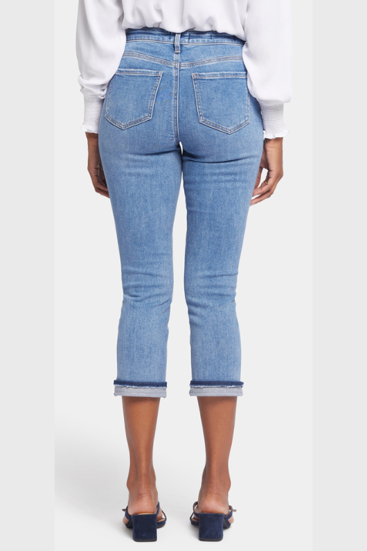 N.Y.D.J Chloe Capri Cuff Jeans. Cropped, women's jeans with button & zip fastening, pockets, shadow cuffs with raw edges and a classic blue denim finish.