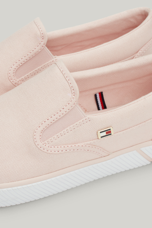 An image of the Tommy Hilfiger Enamel Flag Slip-On Canvas Trainers