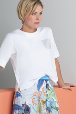 An image of a female model wearing the Bianca Dinia Top - Stud Detail in the colour White.