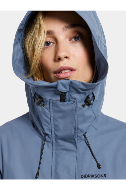 Didriksons Thelma Parka 10. A fully waterproof and windproof jacket with a feminine drawstring waist, pockets, a two-way adjustable hood, and front zip fastening