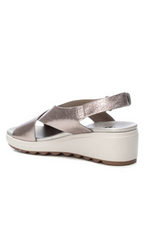 Xti Wedge Sandal. A silver, metallic effect women's sandal with velcro strap fastening, an open toe and criss-cross strap detail