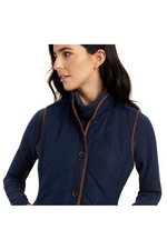 An image of a female model wearing the Ariat Woodside 2.0 Quilted Gilet in the colour Navy.