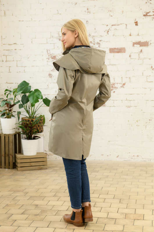 Lighthouse Outrider Waterproof Raincoat. A 3/4 length jacket with a two-way front zip, pockets, a detachable hood with a check lining, and a pale green fawn colour design.