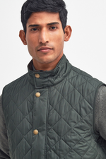 An image of a male model wearing the Barbour Lowerdale Gilet in the colour Sage.