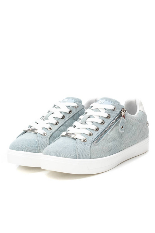 Xti Trainer. A women's trainer with star-shaped stitching on the side, zip closure with decorative laces, and a chic denim effect finish