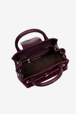 Fairfax & Favor The Mini Windsor. A mini windsor handbag with crossbody strap and tassel details. Suede and leather in the colour Plum.