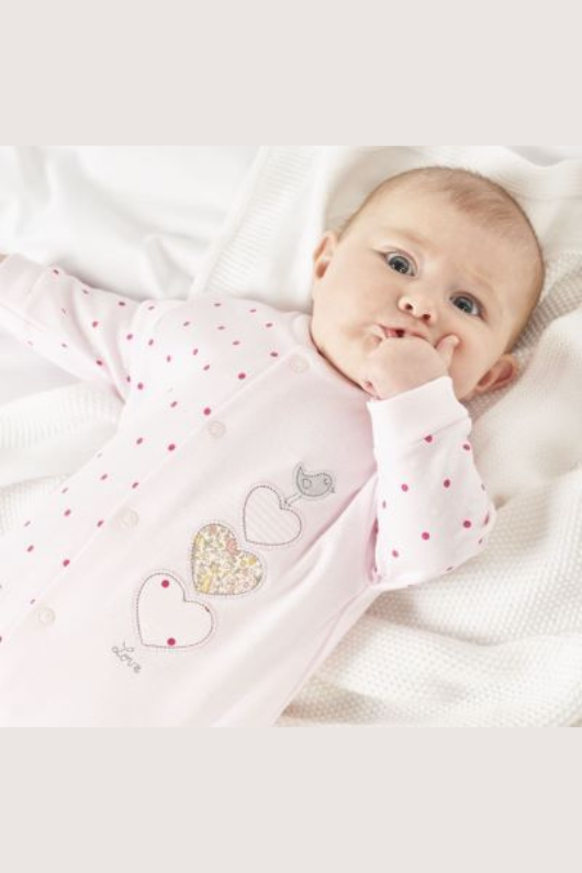 Dandelion Triple Hearts Cotton Sleepsuit. A long sleeve sleepsuit with popper closures and pink design with heart applique.