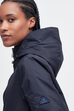 An image of a female model wearing the Barbour Panarth Showerproof Jacket in the colour Dark Navy.