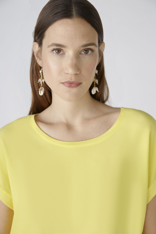 Oui Plain Cap Sleeve T-Shirt. A yellow top with short sleeves, wide neck, and split hem.