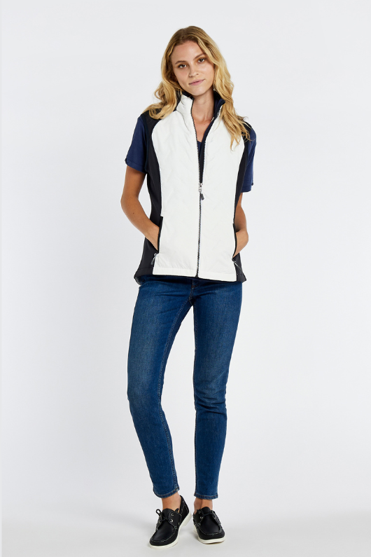 Dubarry Redbarn Gilet in White with Navy detail on the sides. A zip-up gilet with a dipped back hem and rib knit cuff detail