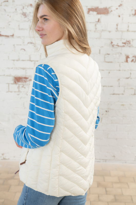 Lighthouse Laurel Gilet. A water repellent, women's gilet with two zip pockets, front zip fastening, faux leather zip pull and a crisp coconut colour finish