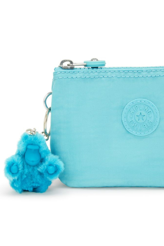 Kipling Creativity Small Purse. A small aqua purse with zipper compartment, multiple inner compartments, Kipling logo, and monkey charm.