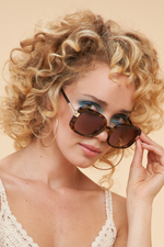 Powder Paige Sunglasses. Large sized sunglasses with a dark glossy frame.