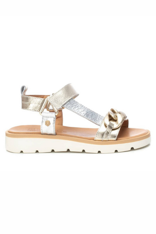 Carmela Sandal. A pair of gold/silver sandals with metallic finish and chain decal, complete with adhesive strip closure and non-slip sole.