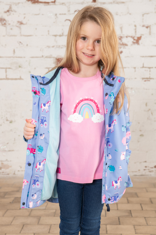 Lighthouse Olivia Jacket. A lightweight, waterproof kids coat with a soft jersey lining, two front pockets, a zip-up front, and a cute farm animal design on a lilac background.