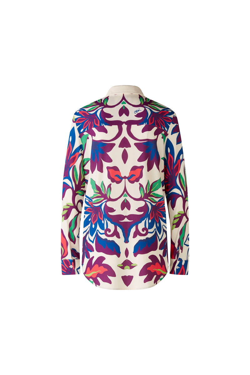 Oui Bold Floral Blouse. A casual cut blouse with long sleeves and collared neckline. This top has a silk touch quality, slightly longer length, and a multicoloured floral print.