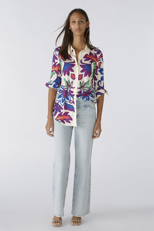 Oui Bold Floral Blouse. A casual cut blouse with long sleeves and collared neckline. This top has a silk touch quality, slightly longer length, and a multicoloured floral print.