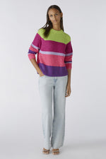 Oui Broad Stripes Jumper. An oversized fit jumper with shortened length. This jumper has long sleeves, round neckline, and a multi-coloured green, pink and purple striped pattern.