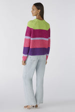 Oui Broad Stripes Jumper. An oversized fit jumper with shortened length. This jumper has long sleeves, round neckline, and a multi-coloured green, pink and purple striped pattern.