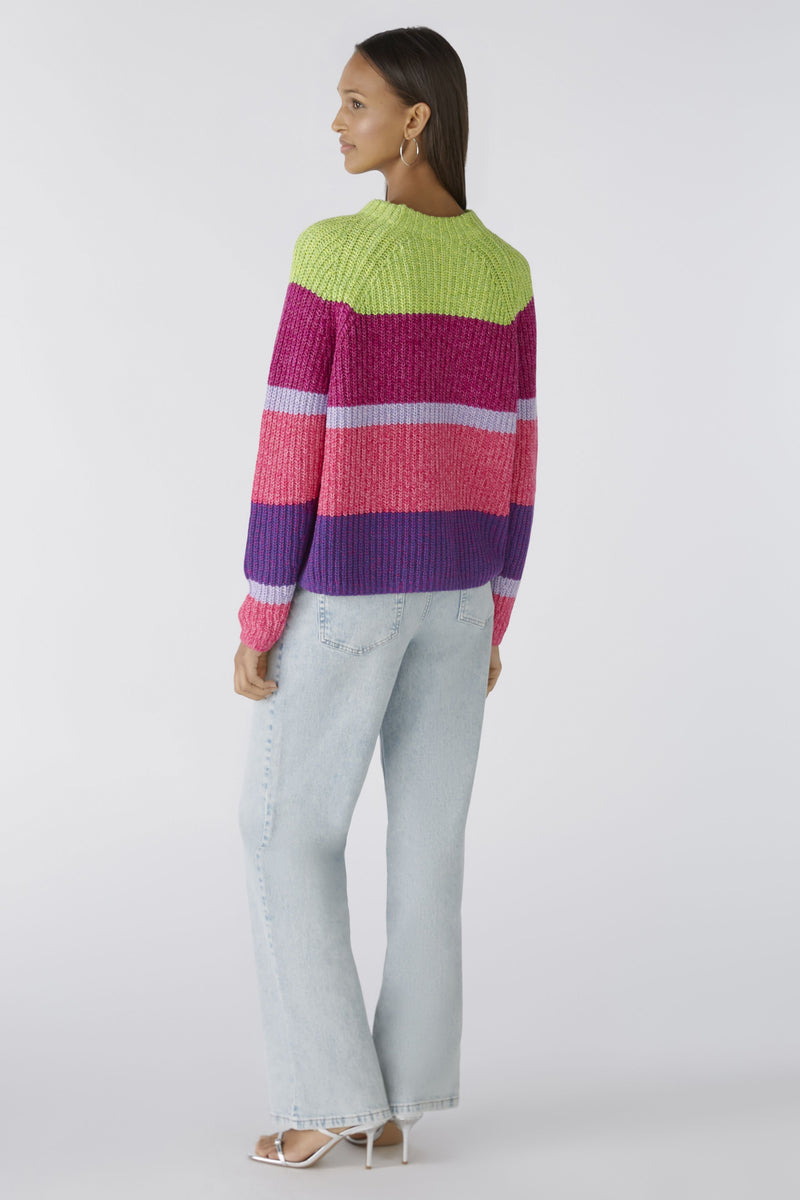 Oui Broad Stripes Jumper. An oversized fit jumper with shortened length. This jumper has long sleeves, round neckline, and a multi-coloured green, pink and purple striped pattern.