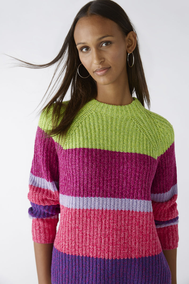 Oui Broad Stripes Jumper. An oversized fit jumper with shortened length. This jumper has long sleeves, round neckline, and a multi-coloured green, pink and purple striped pattern.